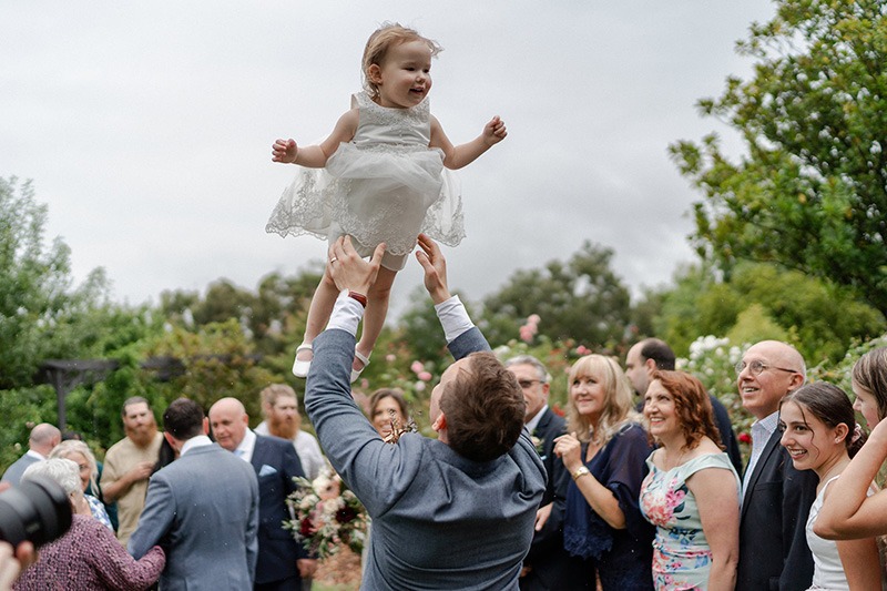 Groom celebrates throwing daughter in air 