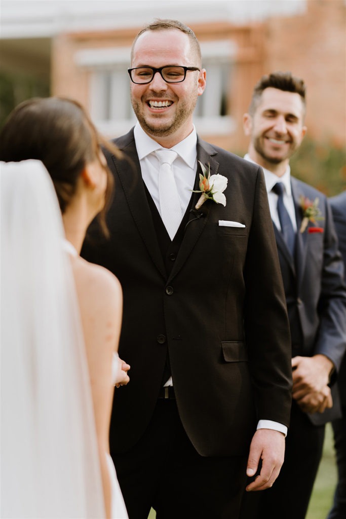 Groom laughing on wedding day 